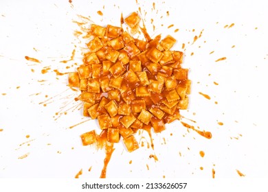 Ravioli In Tomato Sauce Splattered On A White Background.