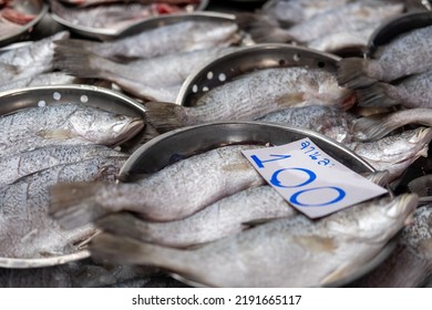 Raw Asian Sea Bass On A Dish With Price Tag In A Market