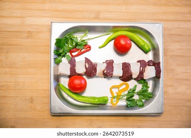 Raw assorted Azerbaijani kebabs prepared for grilling. Traditional minced and marinated meat skewers, ready for barbecue. Authentic Caucasus cuisine with lamb, beef, and chicken varieties.