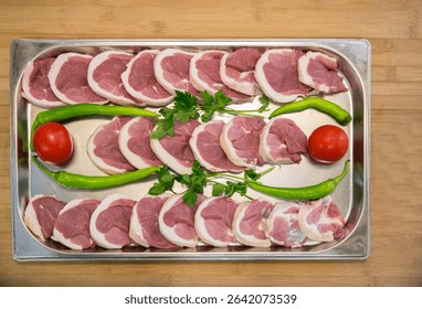 Raw assorted Azerbaijani kebabs prepared for grilling. Traditional minced and marinated meat skewers, ready for barbecue. Authentic Caucasus cuisine with lamb, beef, and chicken varieties.