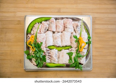 Raw assorted Azerbaijani kebabs prepared for grilling. Traditional minced and marinated meat skewers, ready for barbecue. Authentic Caucasus cuisine with lamb, beef, and chicken varieties.