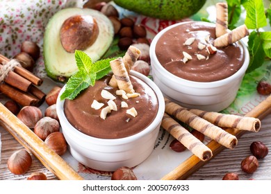 Raw avocado chocolate mousse topped with chocolate and mint, selective focus. Healthy vegan chocolate dessert. - Shutterstock ID 2005076933