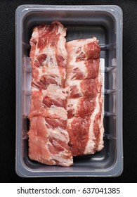 Raw Baby Back Ribs In A Plastic Container.