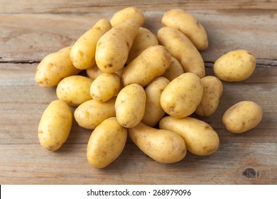 raw baby potatoes on rustic wooden background