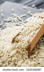 raw basmati rice on a black wooden background. - Shutterstock ID 2245340087