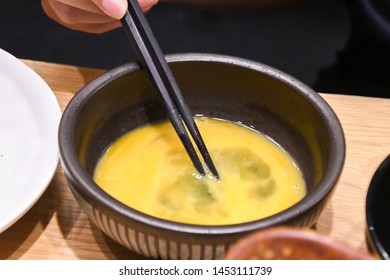 Raw Beaten Egg Yolk In The Bowl In Japanese Shabu Shabu Sukiyaki Restaurant