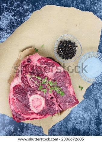 Raw Beef arm roast with kosher salt and black peppercorns