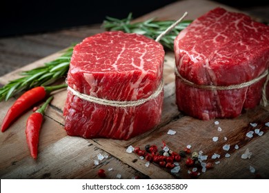 Raw beef filet Mignon steak on a wooden Board with pepper and salt, black Angus marbled meat - Shutterstock ID 1636385809