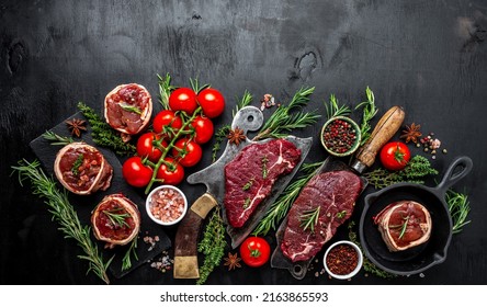 Raw Beef Filet Mignon Steak On With Pepper And Salt, Filet Mignon. Beef Tenderloin Steaks Wrapped In Bacon And Thyme On Dark Background. Long Banner Format. Top View.