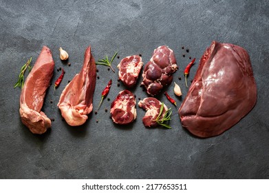 Raw Beef Giblets, Kidney, Liver And Heart Meat On Stone Rustic Table With Thyme And Peppers