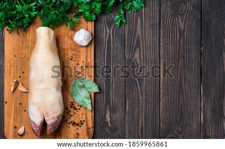 Raw beef hooves for the traditional seasonal dish of khash soup. A dish of boiled cow legs, khash, a dish of the middle east, Turkey and the Caucasus Top view, wooden dark background with copy space