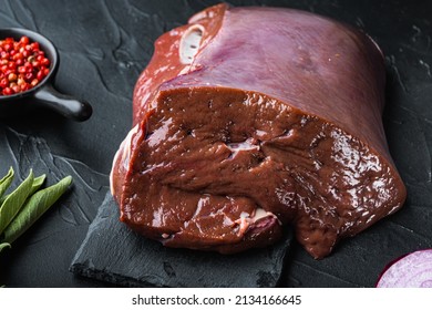 Raw Beef Liver On Black Background.