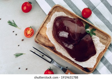 Raw Beef Liver On Wooden Cutting Board