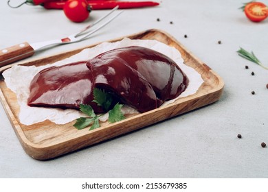 Raw Beef Liver On Wooden Cutting Board