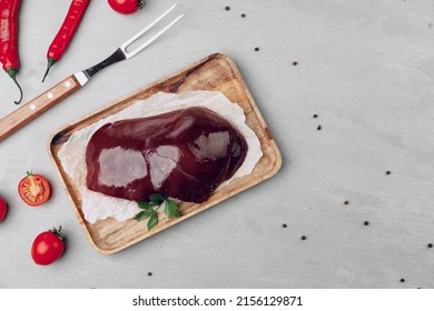 Raw Beef Liver On Wooden Cutting Board