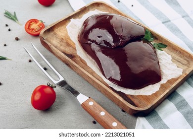 Raw Beef Liver On Wooden Cutting Board