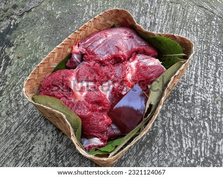 Raw Beef Meat on Bamboo Wooven Box or Besek. Distributing Daging Kurban or Meat Slaughtering using Besek as Eco Packaging. 