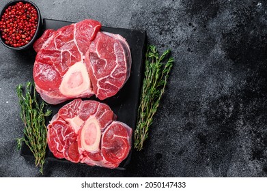Raw beef meat osso buco shank steak, italian ossobuco. Black background. Top view. Copy space
