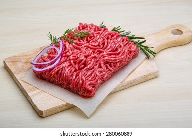 Raw beef minced meat with rosemary and onion