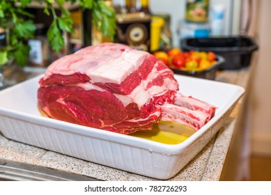 Raw Beef Rib Steak With Bone In Roasting Tray On Wooden Table