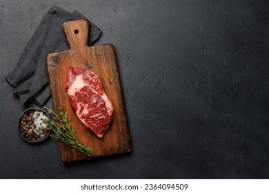 Raw beef ribeye steak, fresh and ready for cooking, promising a mouthwatering culinary experience. Flat lay with copy space - Shutterstock ID 2364094509