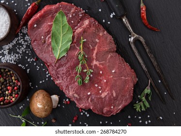 Raw Beef Rump Steak On Black Table, Close-up