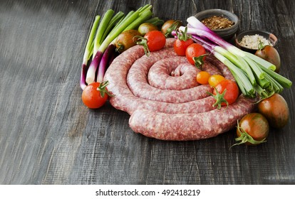 Raw Beef Sausages With Rosemary And Spices On A Wooden Table, South African Boerewors