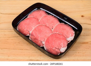 Raw Beef Sirloin Tip In Black Tray On Wooden Background.