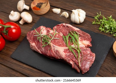 Raw Beef Steak On A Wooden Table. Healthy Food Concept. Beef Tenderloin And Spices For Making Hot Barbecue Sauce