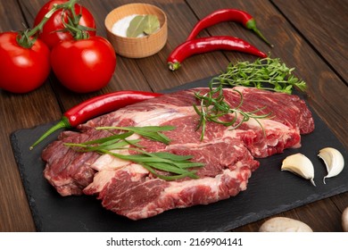 Raw Beef Steak On A Wooden Table. Healthy Food Concept. Beef Tenderloin And Spices For Making Hot Barbecue Sauce