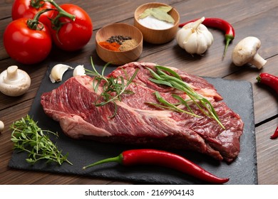 Raw Beef Steak On A Wooden Table. Healthy Food Concept. Beef Tenderloin And Spices For Making Hot Barbecue Sauce