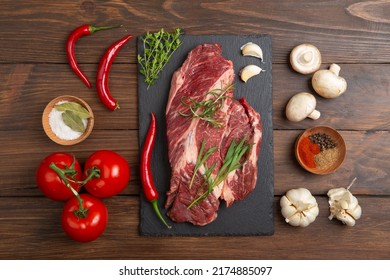 Raw Beef Steak On A Wooden Table. Healthy Food Concept. Beef Tenderloin And Spices For Making Hot Barbecue Sauce