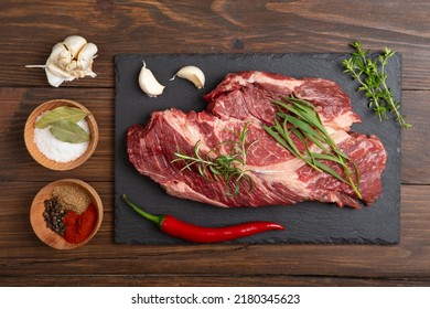 Raw Beef Steak On A Wooden Table. Healthy Food Concept. Beef Tenderloin And Spices For Making Hot Barbecue Sauce