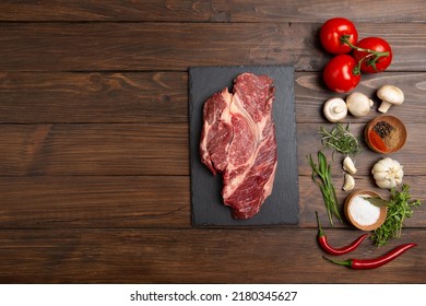 Raw Beef Steak On A Wooden Table. Healthy Food Concept. Beef Tenderloin And Spices For Making Hot Barbecue Sauce