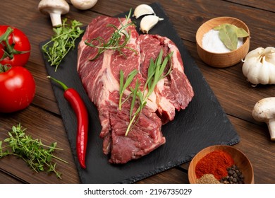 Raw Beef Steak On A Wooden Table. Healthy Food Concept. Beef Tenderloin And Spices For Making Hot Barbecue Sauce