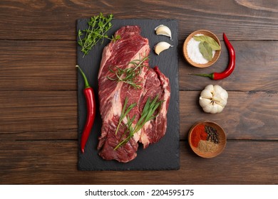 Raw Beef Steak On A Wooden Table. Healthy Food Concept. Beef Tenderloin And Spices For Making Hot Barbecue Sauce