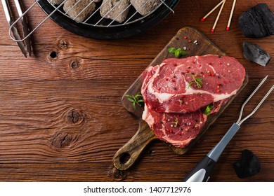 Raw beef steak, ready for grilling. Grill accessories. Concept. Free space for description. Top view. - Powered by Shutterstock