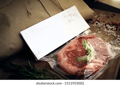 Raw Beef Steak Vacuum Packed On Wooden Table, Mockup For Butcher Shop Or Logo