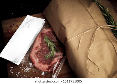 Raw Beef Steak Vacuum Packed On Wooden Table, Mockup For Butcher Shop Or Logo