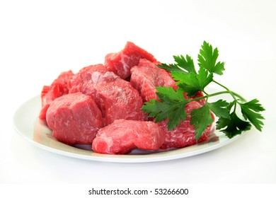 Raw Beef Stew With Lovage On A White Plate