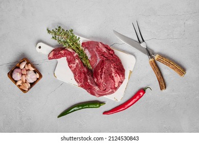 Raw Beef Whole Tenderloin With Herbs And Spice On Concrete Background