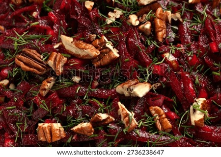 Raw beetroot salad garnished with dill and pecan nuts. Healthy salad, High in fibre.