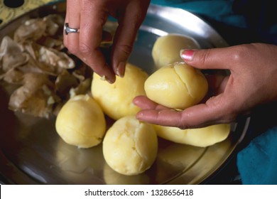Raw boiled potato getting peel off by a lady
