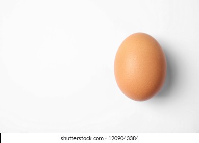 Raw Brown Chicken Egg On White Background, Top View