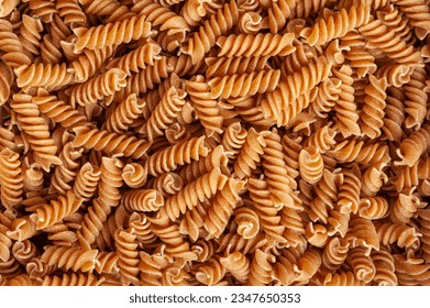 Raw Brown Pasta Texture Background, Wholegrain Fusilli Pattern, Dry Whole Grain Noodle Banner, Raw Spelt Macaroni Mockup with Copy Space for Text, Wholewheat Spiral Pasta Background