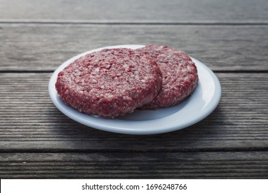 Raw Burger Minced Red Meat On Wooden Background On Plate