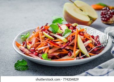 Raw carrot beetroot apple salad with ginger lime dressing on stone background. Selective focus, copy space. - Powered by Shutterstock