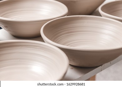 raw ceramic bowls made from white clay on the potter's wheel circle waiting for putting in the pottery kiln, concept of manual work, creativity and art, horizontal photo - Powered by Shutterstock