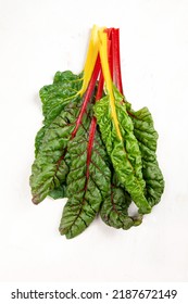 Raw chard on light background. Highly nutritious leaves. Popular component of healthy diets. Top view, copy space