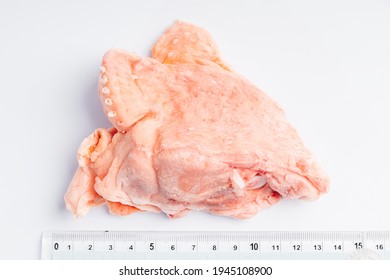 Raw Chicken Back On A White Plate With A Ruler To Accurately Determine The Caliber. Raw Chicken Meat With Bone